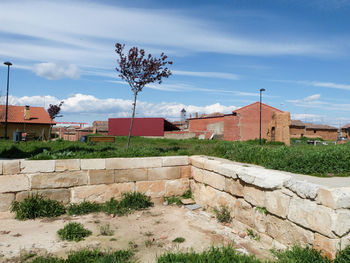 Houses against cloudy sky