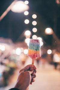 Human hand holding ice cream cone