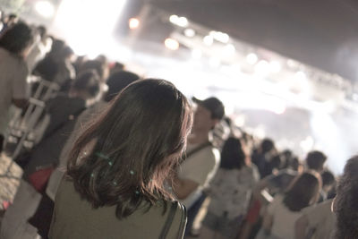 Rear view of people enjoying at music concert