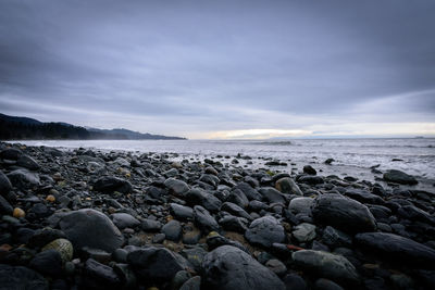 Rocks on beach against sky