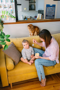 Portrait of happy family sitting on sofa at home