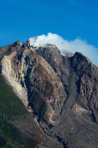 Scenic view of mountains against blue sky