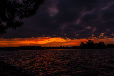 Scenic view of dramatic sky over sea during sunset