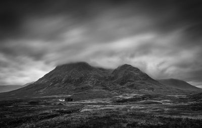 Scenic view of mountains against cloudy sky
