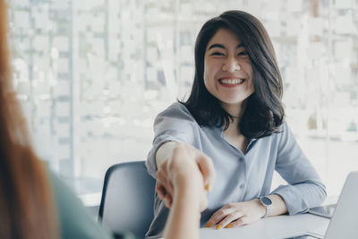 Businessmans handshake after good deal.