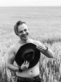 Portrait of smiling young man standing on land