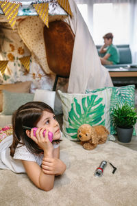 High angle view of woman with stuffed toy