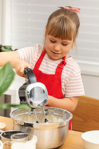 Boy playing with coffee at table