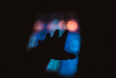 Close-up of human hand against black background