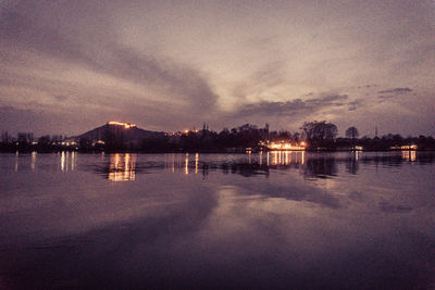 Scenic view of lake against sky at sunset