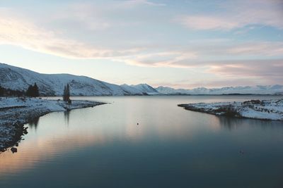 Scenic view of lake against sky during winter