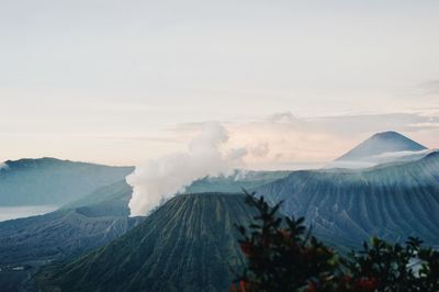 Smoke emitting from volcanic mountain against sky