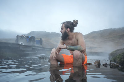 Man with dreadlocks in hot springs river