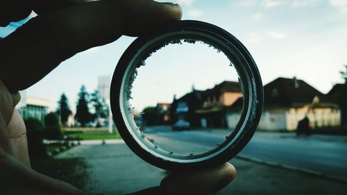 Reflection of man photographing on side-view mirror