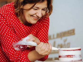 Smiling woman preparing food at home