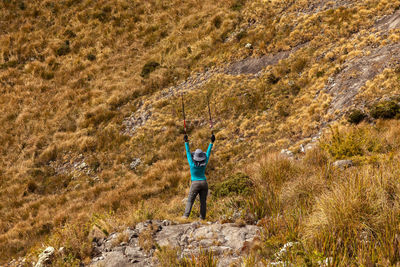 Full length rear view of man standing on rock