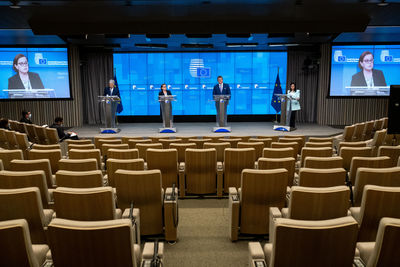 Rear view of people on empty chairs