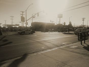 Cars on road in city against sky