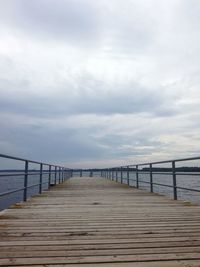 Pier over sea against sky