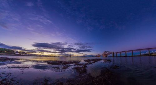 View of bridge over sea against blue sky