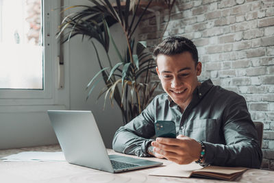 Young man using laptop at office