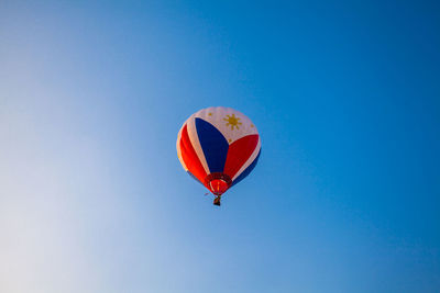 Low angle view of hot air balloon against clear blue sky