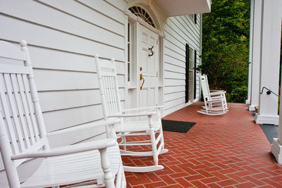 Empty chairs and tables outside building