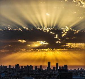 Scenic view of buildings against sky during sunset
