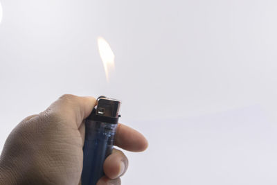 Close-up of hand holding burning candle