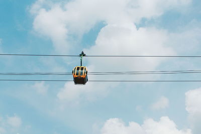 Low angle view of cable car against sky