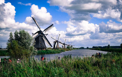 Traditional windmill on field against sky