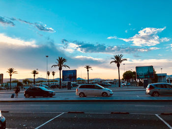 Cars on road against blue sky