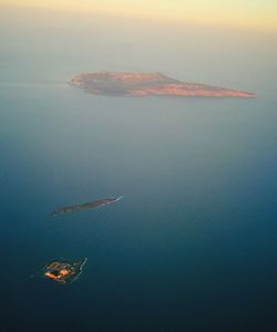 Aerial view of sea against sky at sunset