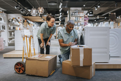 Diverse male and female sales clerks working in appliances store