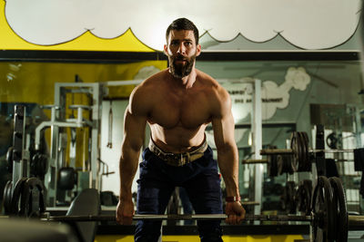 Portrait of shirtless man standing at home