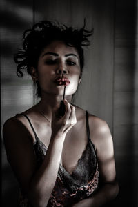 Thai woman applying lipstick