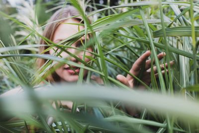 Young woman amidst grass