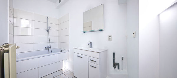 Panoramic view of a freshly renovated white bathroom
