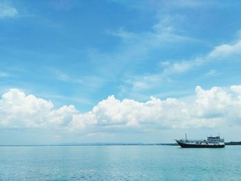 Boat sailing in sea against sky