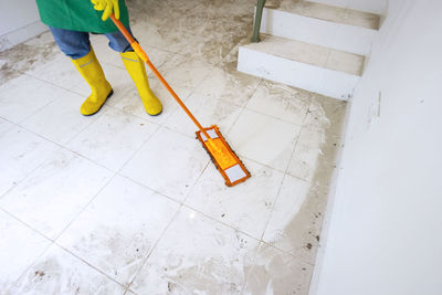 Low section of person working on floor at home