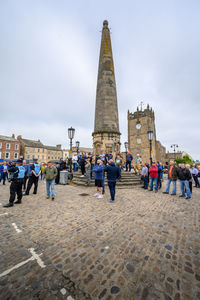 People at town square against sky