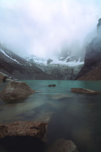 Scenic view of lake against sky during winter