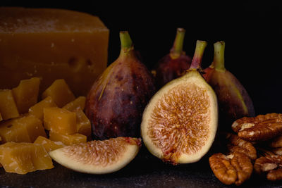 Close-up of fruits on table against black background