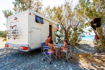 Rear view of woman sitting on beach