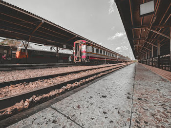 Train at railroad station against sky