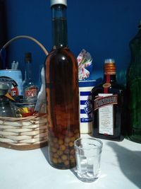 Glass of bottles on table