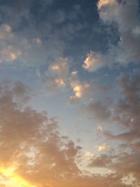 Low angle view of cloudy sky at sunset