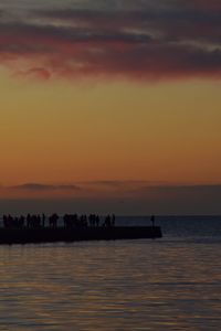 Scenic view of sea against orange sky