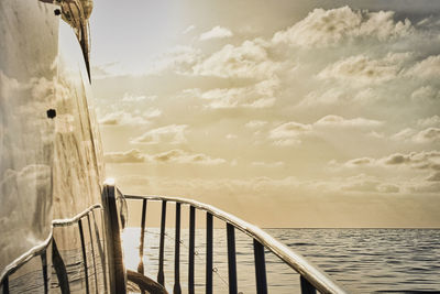 Boat in sea against sky during sunset