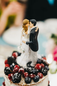 Close-up of couple on top of dessert